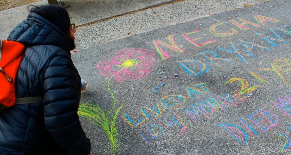 Rita Bobry chalking a memorial for her great-aunt Necha